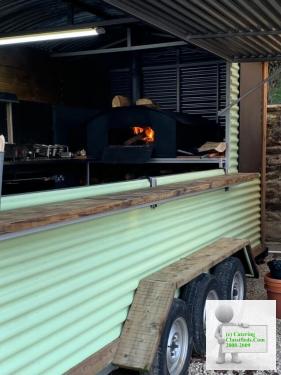 Mobile catering trailer with wood fired pizza oven